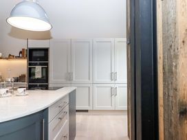 A kitchen with cabinets and an island at Duke's Barn Blackawton near Dartmouth