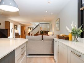 A living room with a sofa and kitchen island at Duke's Barn Blackawton near Dartmouth
