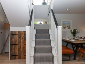 A staircase leading to a dining area at Duke's Barn in Blackawton near Dartmouth
