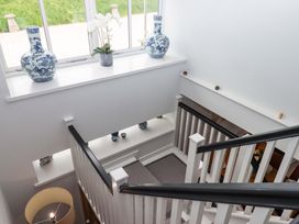 A staircase with vases and a flower pot at Duke's Barn Blackawton near Dartmouth