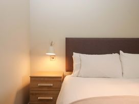 A bedroom with a bed and bedside table at Duke's Barn Blackawton near Dartmouth