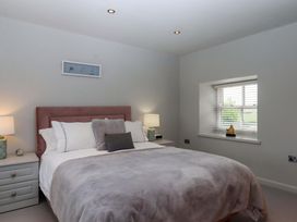 A bedroom with a bed and lamps at Duke's Barn Blackawton near Dartmouth