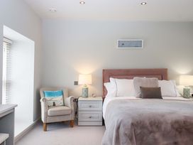 A bedroom with a bed and nightstand at Duke's Barn in Blackawton near Dartmouth