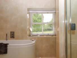 A bathroom with a bathtub and shower at Duke's Barn in Blackawton near Dartmouth