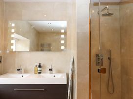 A bathroom with a double basin and shower at Duke's Barn Blackawton near Dartmouth