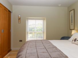 A bedroom with a bed and wardrobe at Duke's Barn Blackawton near Dartmouth