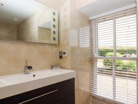 A bathroom with a sink and mirror at Duke's Barn in Blackawton near Dartmouth