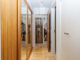 A hallway with mirrors and a staircase at Duke's Barn Blackawton near Dartmouth