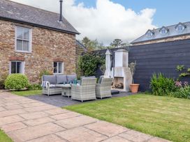 A garden with seating area and fireplace at Duke's Barn Blackawton near Dartmouth