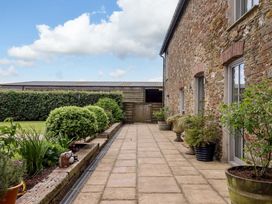 An outdoor area with paving stones and plants at Duke's Barn Blackawton near Dartmouth
