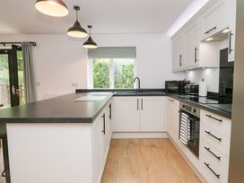 A kitchen with cabinets and a counter at Catbells in Windermere