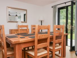 A dining room with a wooden table and chairs at Catbells in Windermere
