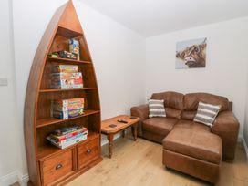 A living room with a bookshelf and a sofa at Catbells in Windermere