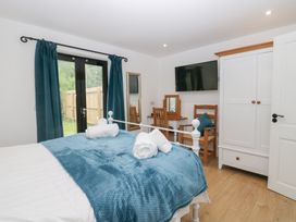 A bedroom with a double bed and television at Catbells in Windermere