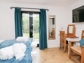 A bedroom with a bed and a table at Catbells in Windermere