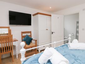 A bedroom with a bed and a television at Catbells in Windermere