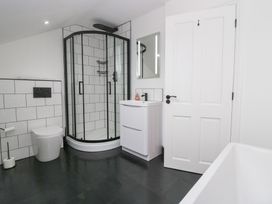 A bathroom with a shower, toilet, and sink at Catbells in Windermere