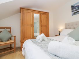 A bedroom with a bed and wardrobe at Catbells in Windermere