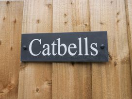 A sign with the name Catbells on a wooden fence at Catbells in Windermere