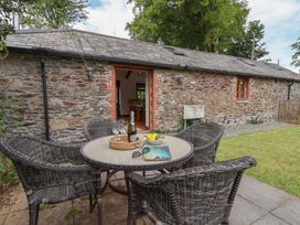 An outdoor seating area with a table and chairs at The Coach House in Tavistock