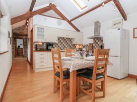 A kitchen with dining table and chairs at The Coach House in Tavistock