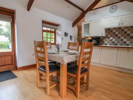 A dining room with a table and chairs at The Coach House in Tavistock