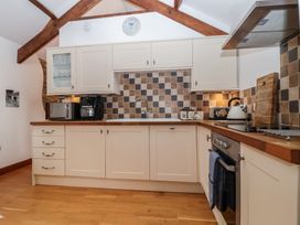 A kitchen with cabinets and appliances at The Coach House in Tavistock