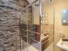 A bathroom with a shower and sink at The Coach House in Tavistock
