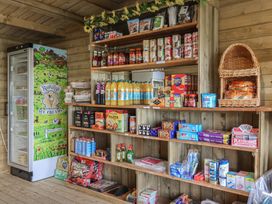 A shop with shelves of snacks and beverages at The Coach House in Tavistock