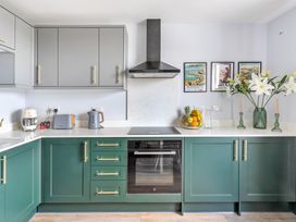 A kitchen with cabinets and appliances at The Sundial St Austell
