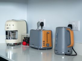 A coffee machine, toaster, and kettle on a countertop at The Sundial in St Austell