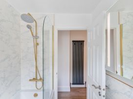 A bathroom with a shower and bathtub at The Sundial in St Austell