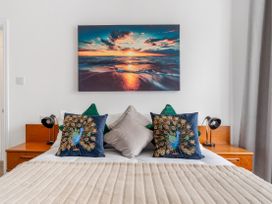 A bedroom with a bed and decorative pillows at The Sundial in St Austell