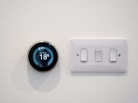 A thermostat and light switches on a wall at The Sundial in St Austell