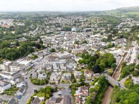 An aerial view of a town with buildings, roads, and greenery at The Sundial in St Austell