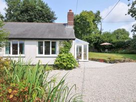 A house with a conservatory and gravel driveway at Upper Court Cottage Broad Langdon near Wainhouse Corner