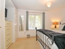 A bedroom with a bed and dresser at Upper Court Cottage in Broad Langdon near Wainhouse Corner