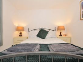 A bedroom with a bed and bedside tables at Upper Court Cottage Broad Langdon near Wainhouse Corner