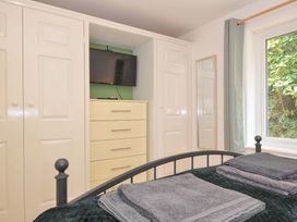 A bedroom with a bed and storage furniture at Upper Court Cottage Broad Langdon near Wainhouse Corner