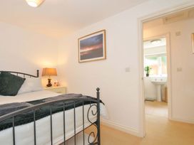 A bedroom with a bed and adjacent bathroom at Upper Court Cottage in Broad Langdon near Wainhouse Corner