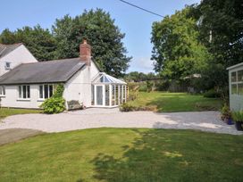 A house with a conservatory and garden at Upper Court Cottage Broad Langdon near Wainhouse Corner