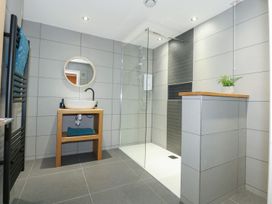 A bathroom with a shower and basin at Criw in Bryncroes near Sarn Meyllteyrn