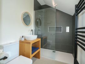 A bathroom featuring a shower, sink, and toilet at Criw, Bryncroes near Sarn Meyllteyrn