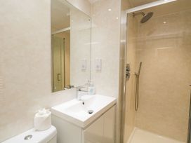A bathroom with a sink and shower at Owls Nook Lodge, Langdale 9, White Cross Bay near Windermere