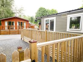 An outdoor area with mobile homes and a wooden deck at Owls Nook Lodge Langdale 9 White Cross Bay near Windermere