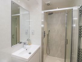 A bathroom with a sink and shower at Owls Nook Lodge, Langdale 9, White Cross Bay near Windermere