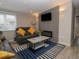 A living room with a sofa and coffee table at Owls Nook Lodge, Langdale 9, White Cross Bay near Windermere