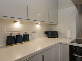 A kitchen with a countertop and kitchen appliances at Owls Nook Lodge, Langdale 9, White Cross Bay near Windermere
