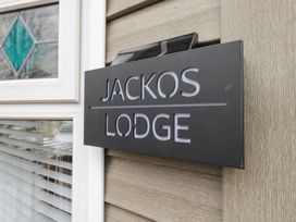 A sign displaying 'JACKOS LODGE' next to a window