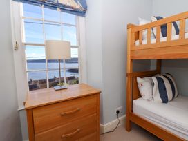 A bedroom with a bunk bed and lamp at Zenobia in New Quay